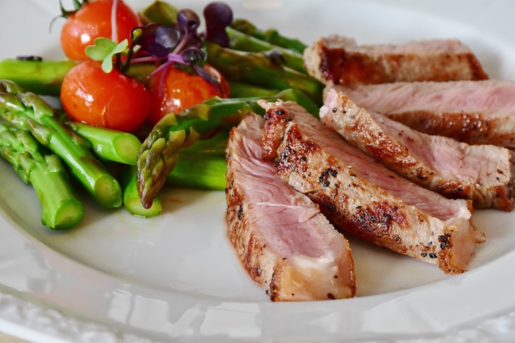 ham asparagus and tomatoes on plate