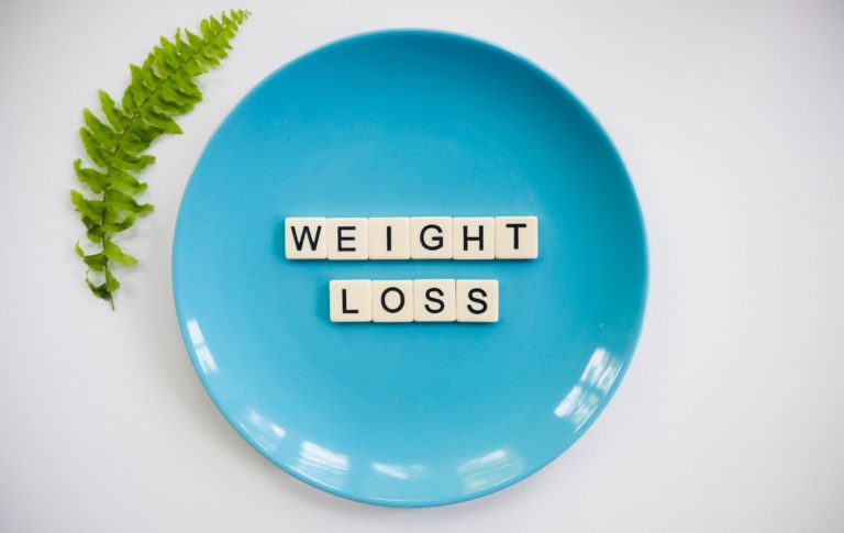 words weight loss on a blue plate